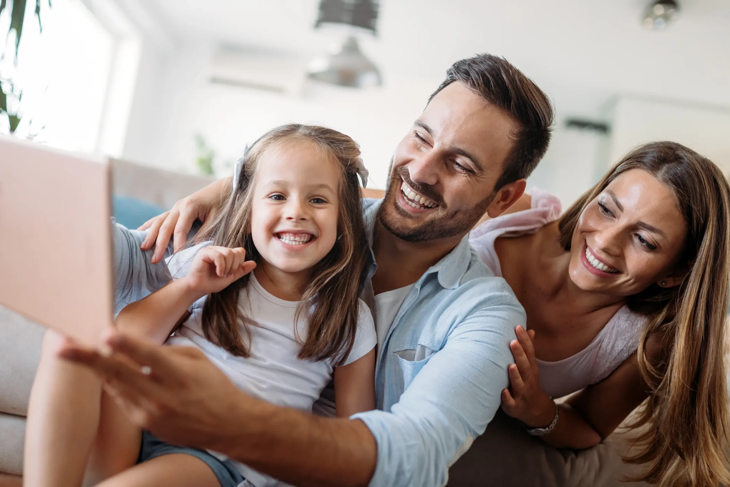 Happy family relaxing together on the couch at home