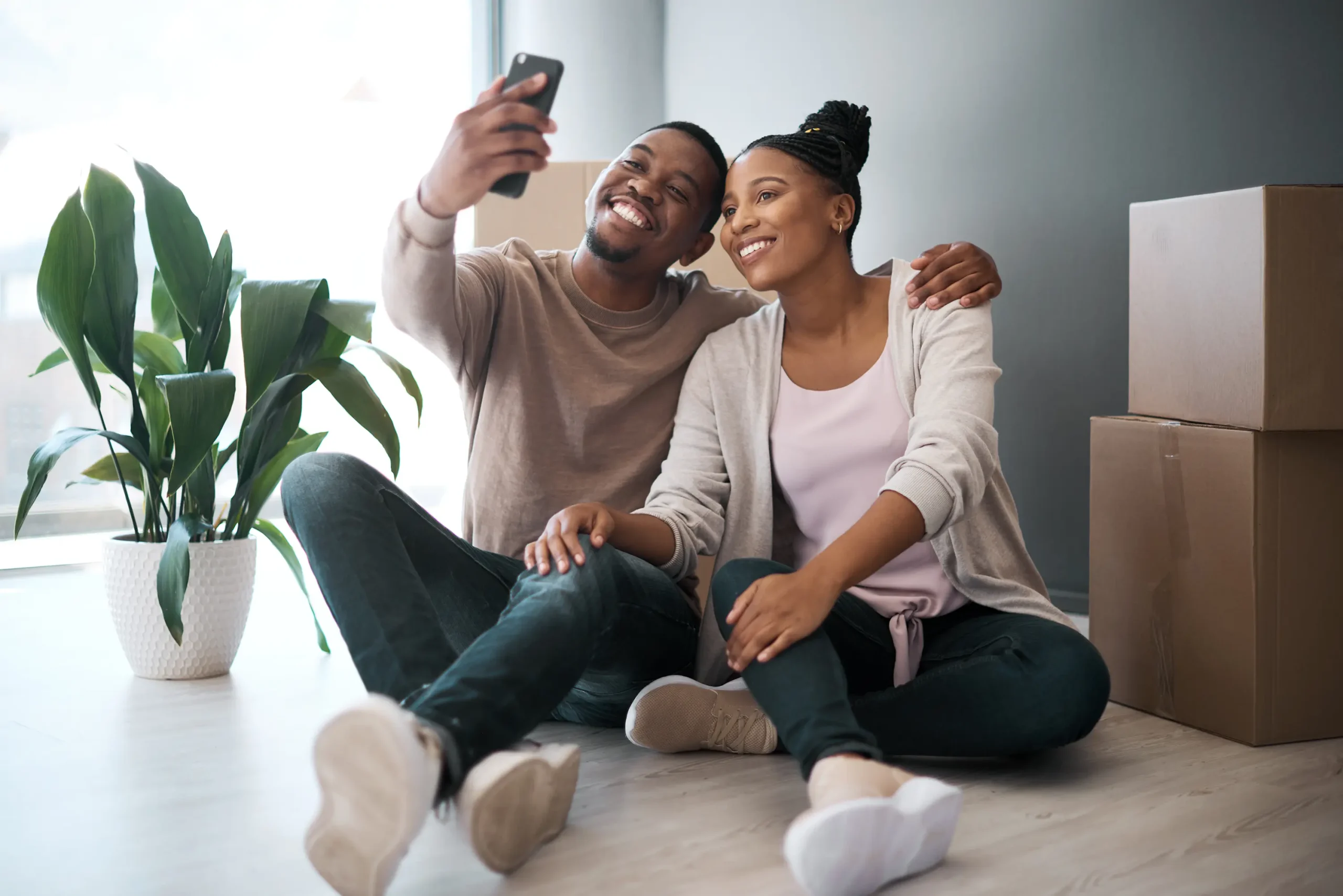 Couple taking a selfie on moving day in their new home